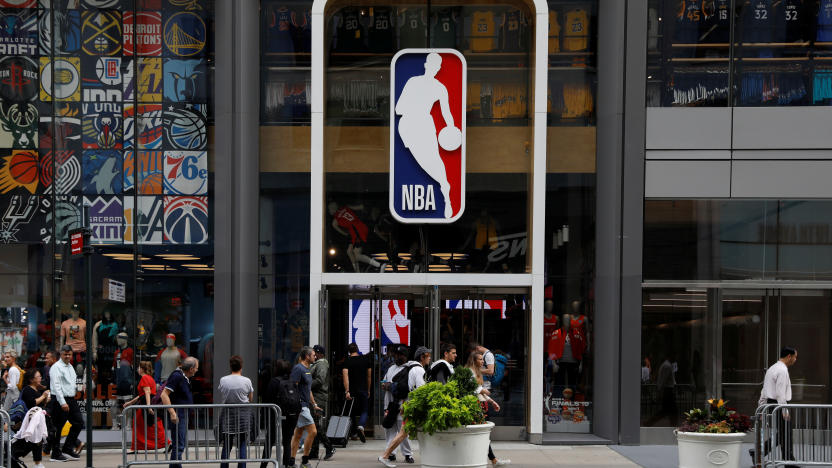 FILE PHOTO: The NBA logo is displayed as people pass by the NBA Store in New York City, U.S., October 7, 2019. REUTERS/Brendan McDermid/File Photo