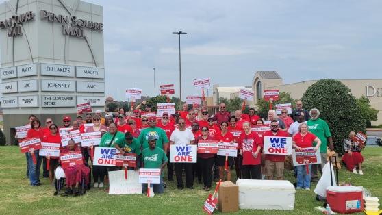 Employees of the Apple Store in Oklahoma City hold a picket outside of the Town Square Mall.