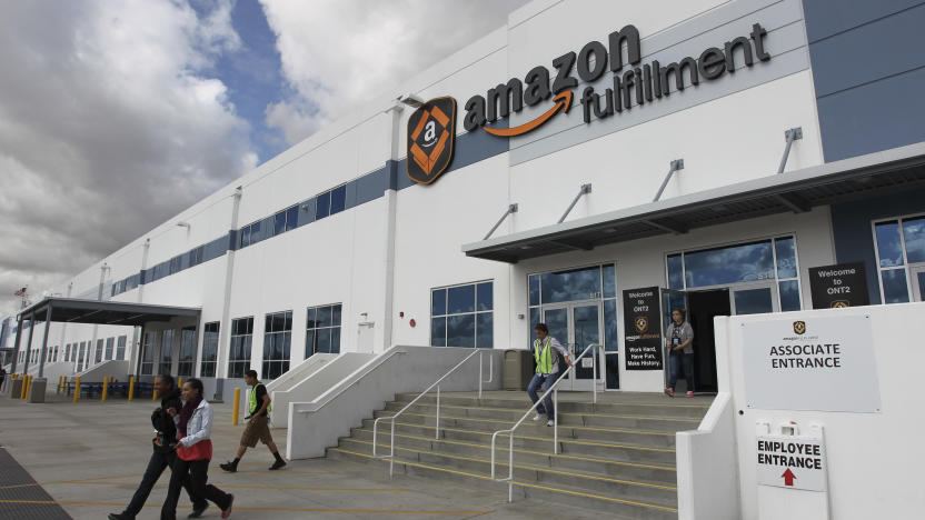 FILE - People leave the entrance to the Amazon San Bernardino Fulfillment Center, October 29, 2013 in San Bernardino, Calif. California has hit Amazon with two separate fines totaling $5.9 million, alleging the e-commerce giant violated a law designed to protect warehouse employees from requirements that they work so quickly that it risks their safety, officials said Tuesday, June 18, 2024. (AP Photo/David McNew, File)