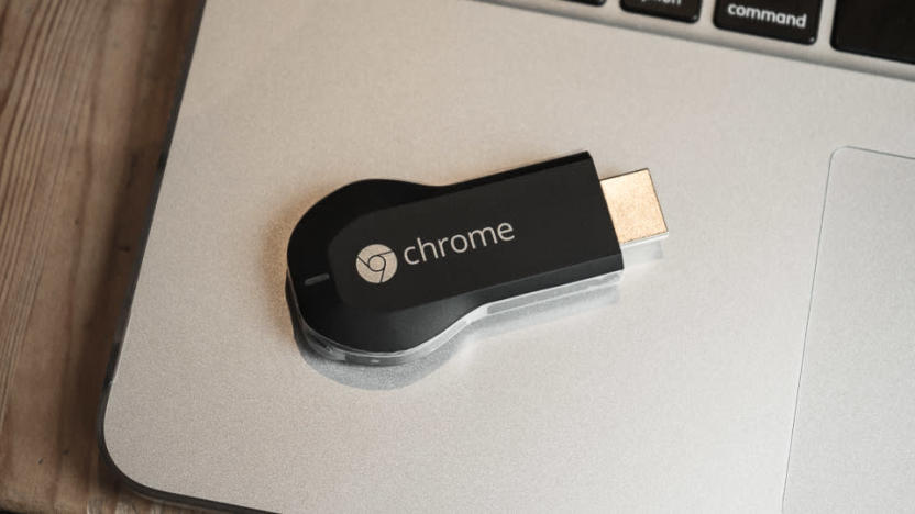 A Google Chromecast (2013) sitting on an old MacBook Pro’s palm rest.