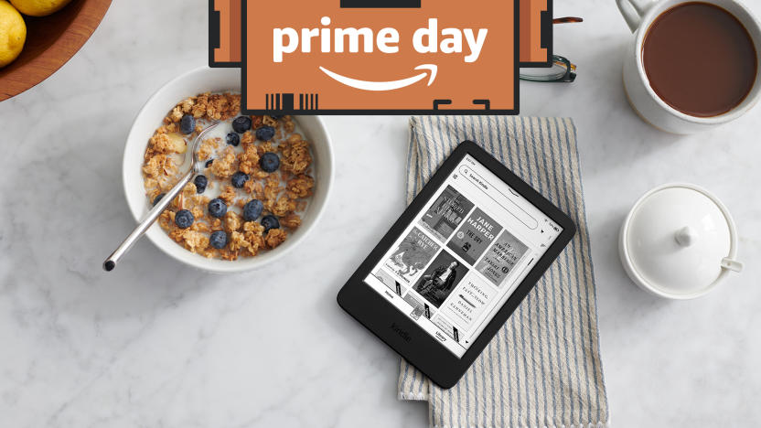 An e-reader, a bowl of cereal and a mug of coffee on a white table. 