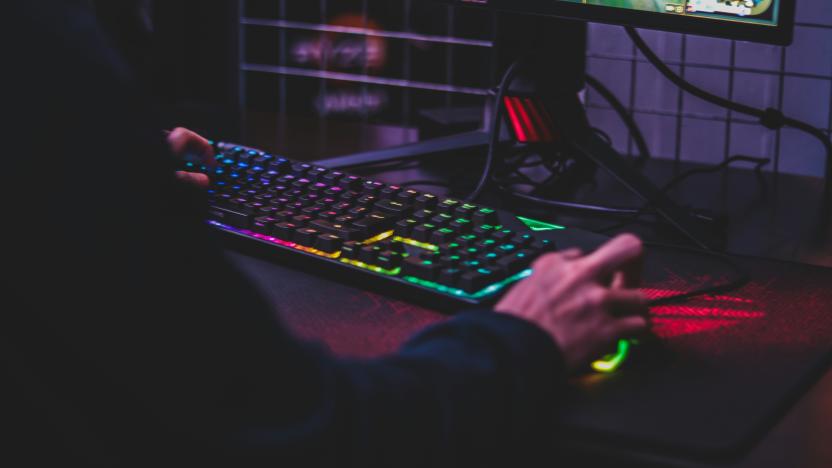 A person uses a keyboard and mouse to play a PC game.