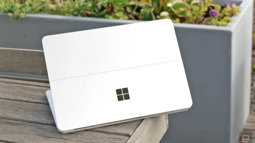 A white device with the Microsoft Windows logo on top of a wooden bench.