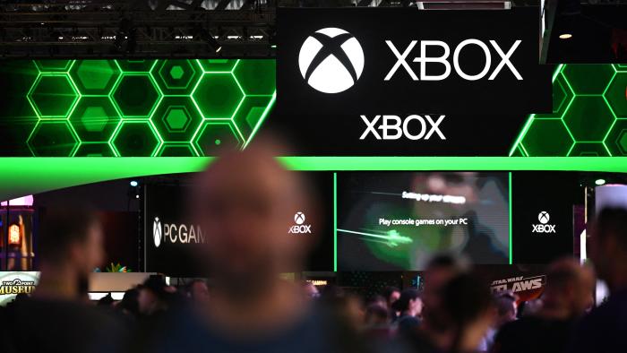 Visitors walk past the Xbox booth at the Gamescom video games trade fair in Cologne, western Germany on August 22, 2024. According to organisers, around 1400 exhibitors from 64 countries will be presenting their products during the fair running until August 25, 2024. (Photo by Ina FASSBENDER / AFP) (Photo by INA FASSBENDER/AFP via Getty Images)