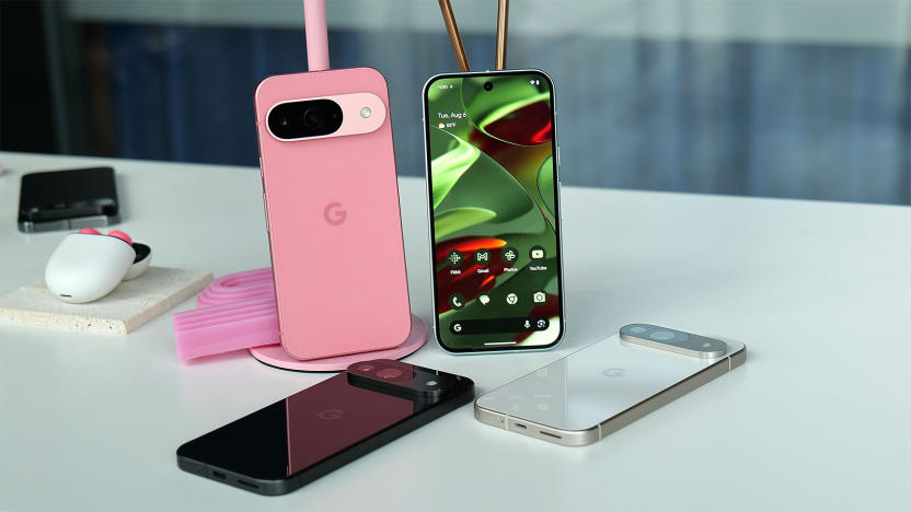 Various Google Pixel 9 phone handsets are arrayed on a white table. 