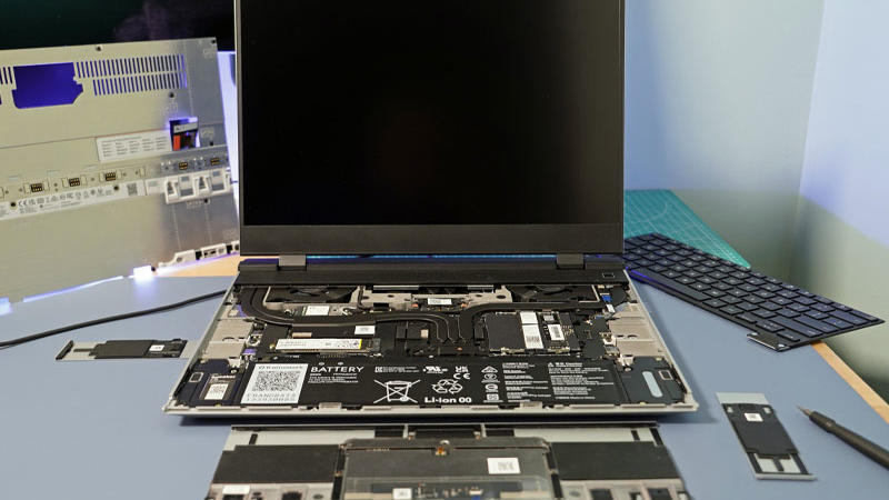 A Framework Laptop 16 laptop is shown open with its internals exposed and displayed in or around its casing.