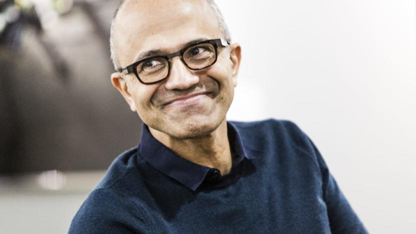 Photo of Microsoft CEO Satya Nadella looking to his right and grinning knowingly.