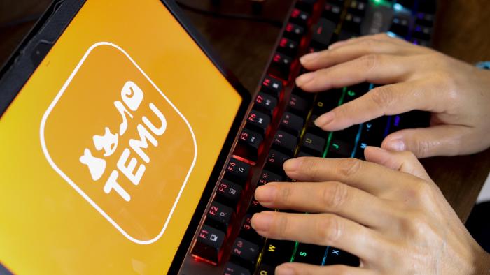 PARAGUAY - 2024/07/12: In this photo illustration, a person types next to the Temu logo displayed on the screen of a tablet. (Photo Illustration by Jaque Silva/SOPA Images/LightRocket via Getty Images)