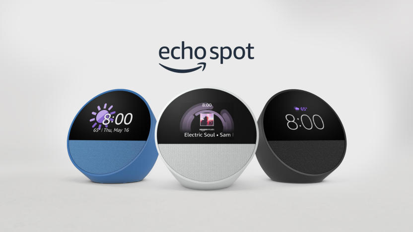 A trio of the new Echo Spot by Amazon, in blue, white and black. The Echo logo followed by the word Spot are hovering above the devices.