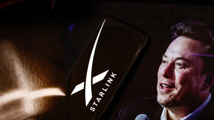 LONDON, UNITED KINGDOM - 2024/07/02: In this photo illustration, the Starlink logo is displayed on a smartphone screen and a computer screen displaying a portrait of Elon Musk, who is the owner of Starlink. The company recently introduced Starlink Mini. (Photo Illustration by Dominika Zarzycka/SOPA Images/LightRocket via Getty Images)