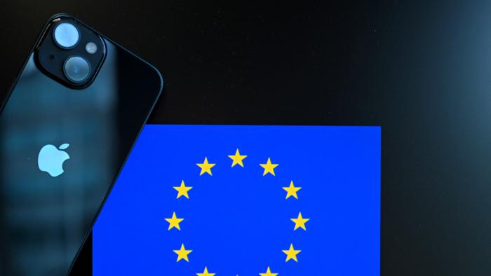 This photograph shows a smartphone with the Apple company logo (L) and the European Union logo (R), in Brussels on September 9, 2024. The European Court of Justice is set to give a ruling on Irish tax breaks to US company Apple on September 10, 2024. (Photo by Nicolas TUCAT / AFP) (Photo by NICOLAS TUCAT/AFP via Getty Images)